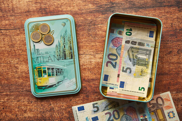 banconote e monete in euro in una latta di cioccolato