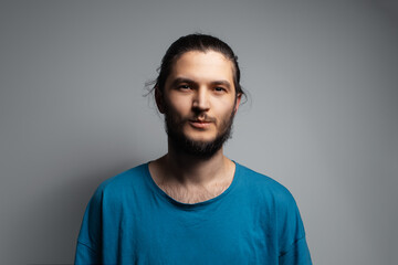 Face of young man while eating candy. Studio portrait.