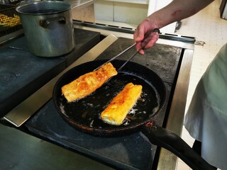Frying pizza roll pancakes. Fried wrapped pizza pancakes in a pan