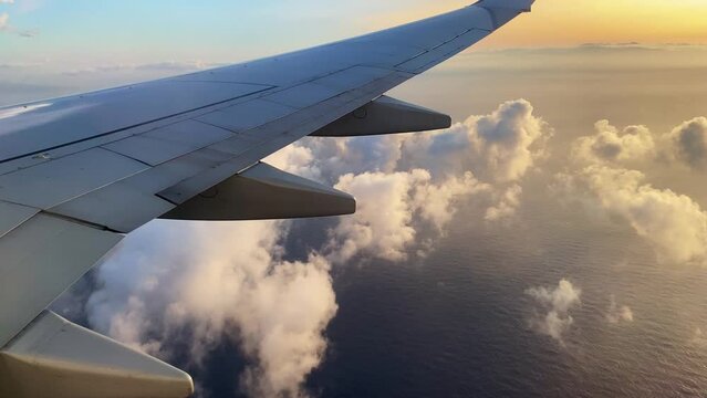 Aircraft flying slowly over a beautiful cloudy sunset between Reunion island et Mayotte