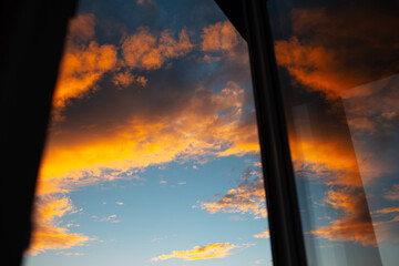 View of beautiful sunset through apartment window.