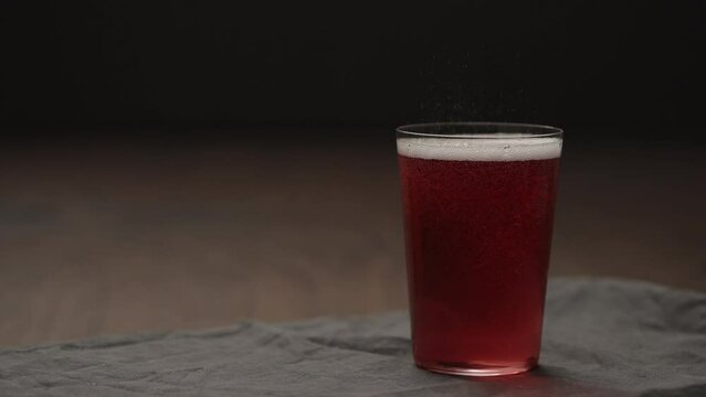 Slow motion berry drink into tumbler glass with copy space