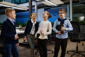 Positive children team laughing in business office