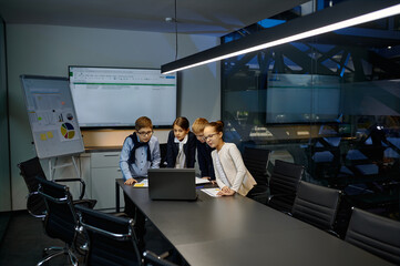 Fototapeta premium Diverse children business team analyzing financial data
