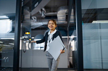 Business girl entering conference room with smile