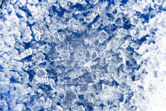 Macro close up of ice crystals on a blue background. 3d visual depth. Color abstract grunge background. Colorful small squares. Futuristic backdrop, modern banner, stylish wallpaper. Design pattern
