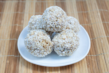 Original Thai popped rice (Khao Tok Tang) is traditional Thai desserts in white plate on the table.