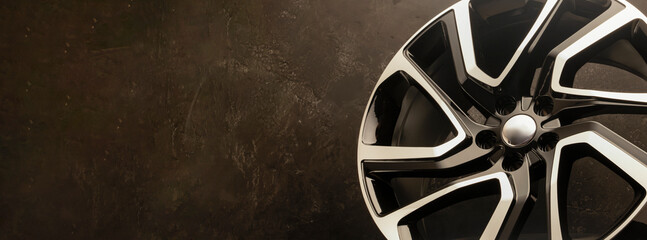 new stylish cool alloy wheel on the tire dark textured background, beautiful and expensive 20 -21,...