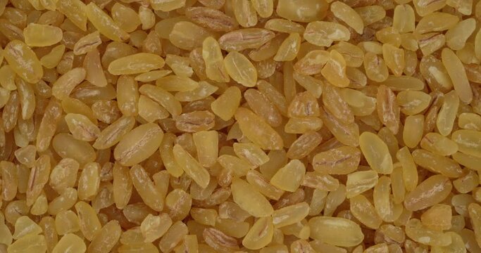 Top view of bulgur wheat rotating. Closeup. Macro.