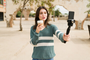 Young woman vlogging at a cafe