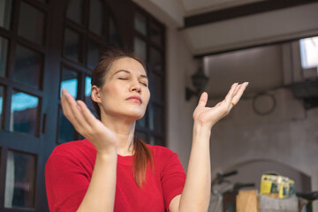 Asian woman praying with hands and believe in God