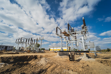 Construction of a power transmission substation on a background of blue sky