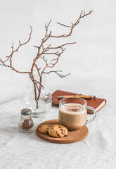 Coffee break - coffee, cookies with chocolate drops on the table in a cozy kitchen interior