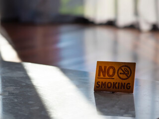Wooden sign no smoking in hotel room.