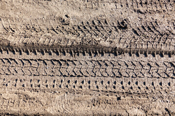 automobile tire marks on mud, tire marks on mud, tire tread marks on mud,