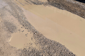 mud and dirty water puddle formed as a result of rain,