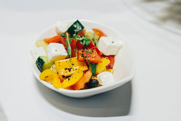 Vegetable salad in a bowl. Large chunks of vegetables in olive oil.