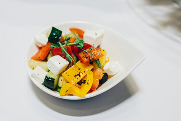 Vegetable salad in a bowl. Large chunks of vegetables in olive oil.