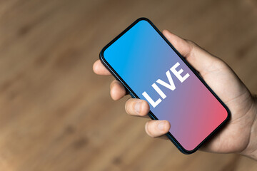 Live - hand holding a phone