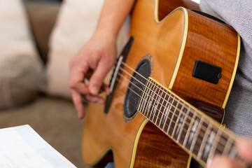 Close-up of the hands of a guitarist playing the guitar.