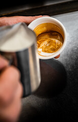 Barista hand making cappuccino Coffee with espresso and milk in cafe