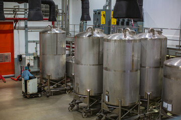 Stainless vertical steel tanks with equipment tank chemical cellar at the with scrolling wheel...