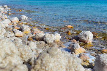 Close up of salt background. Natural salt. Dead Sea salt mineral natural formations. Salt crystals from Dead sea. View of Dead Sea coastline. Texture of Dead sea. Salty seashore rocks