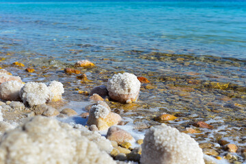Close up of salt background. Natural salt. Dead Sea salt mineral natural formations. Salt crystals from Dead sea. View of Dead Sea coastline. Texture of Dead sea. Salty seashore rocks