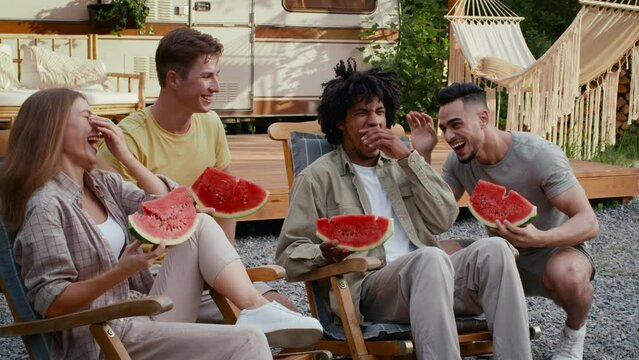 Group Of Happy Multiethnic Friends Eating Watermelon At Outdoor Party In Camping