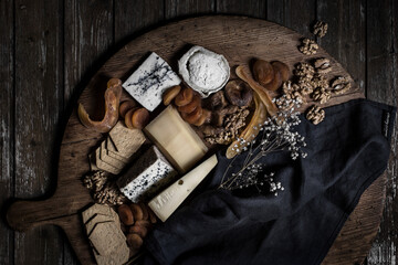 Low key composition with cheese and dry fruits