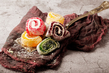 Traditional Turkish delight with Turkish tea on gray background. Ramadan Kareem celebration concept. Fragrant Turkish tea and Turkish sweets in national dishes.