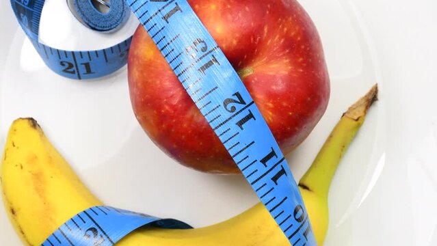 measuring tape with apple and banana on a turn table
