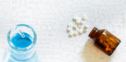 Pills and pill bottles on white background,Science glass test tube,Analyzing samples,Scientists have experimented with antibiotics in vitro,Hand drawn science formulas on chalkboard for background. © banjongseal324