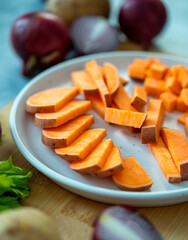 Sweet potato on a wooden board. Preparing vegetable soup