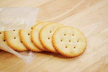 Package Round Crackers Falling onto a Wooden Table	