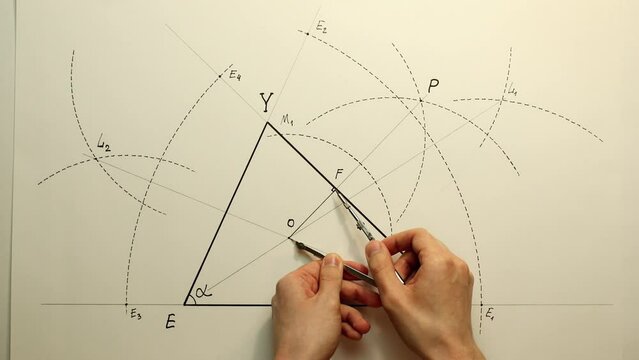 Young mathematician hands drawing inscribed circle in triangle with using a compass. Date of shooting day 26 January 2022 year, MSK time. This video was filmed in Russia.