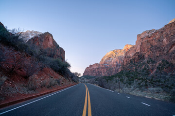 Low Angle View of Two Way Road leading into Zion National Park with Blue Skies