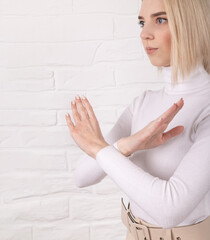 Break the bias symbol of woman's international day. The arms of a girl in white are crossed on a...