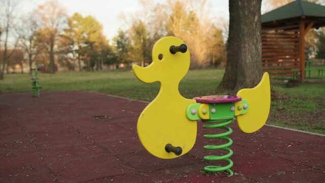 Coil spring playground rocker in empty park