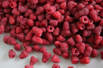  lots of ripe raspberries on a white background, top view