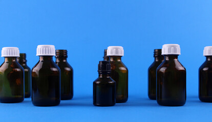 Glass bottles for medication on a blue background