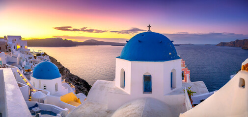Picturesque sunset on famous view resort over Oia town on Santorini island, Greece, Europe. famous...