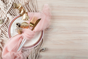  Easter table setting in boho style. Plate, cutlery and quail eggs on the Easter table, copy space for text