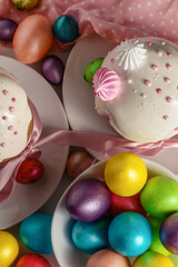 easter pastries and traditional multicolored eggs on the festive table, top view