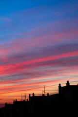 colourful sunset sky and cityscape silhouettes