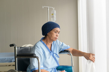 Portrait of senior cancer patient woman wearing head scarf in hospital, healthcare and medical...