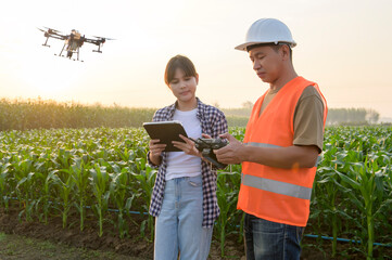 Male engineer  provide a consultation and instructing to smart farmer with drone spraying...