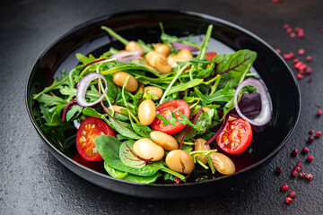salad white beans, tomato, leaves lettuce mix petals fresh portion healthy meal food diet snack on the table copy space food background keto or paleo diet veggie vegan or vegetarian food no meat