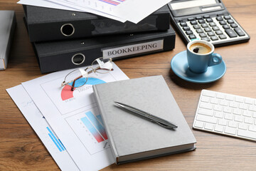 Bookkeeper's workplace with folders and documents on table