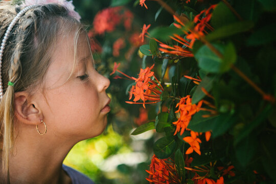 Girl Smells Beautiful Orange Tropical Flowers